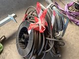 a hose that is sitting on the ground next to a pair of shoes