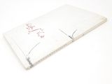 a white book with red writing on it sitting on a table