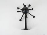 a black clock on a white wall with a white background