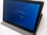 a tablet with a blue screen sitting on a table