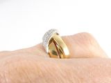 a woman ' s hand with a gold and diamond ring on it