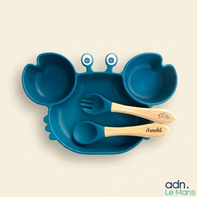 a blue plate with two spoons and two spoons in the shape of a crab