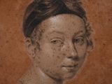 portrait of a woman with freckles and a bun on her head
