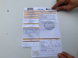 someone is holding a piece of paper that has been placed on a table
