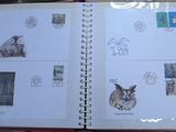 an open book with stamps on it sitting on a table