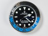 a black and blue rolex watch on a white surface