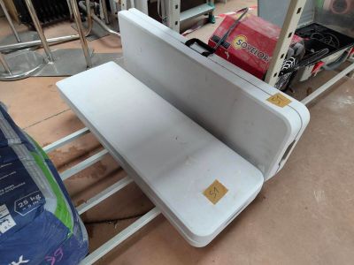 a laptop computer sitting on top of a metal rack