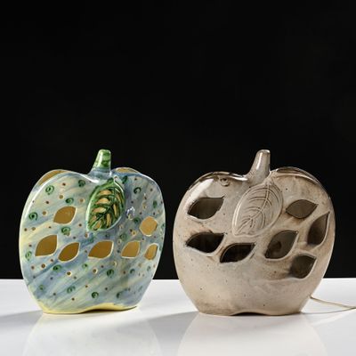 two apple shaped vases sitting on a white table