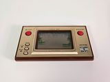 a close up of a small game console on a white surface