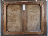 an old picture of a wooden frame with a tag on it