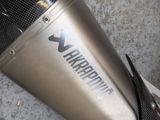 a close up of a motorcycle exhaust pipe on the ground