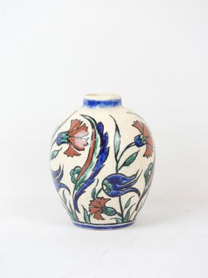 a vase with a floral design on it on a white surface
