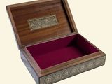 a wooden box with a red velvet lining inside