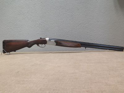 a rifle that is sitting on top of a table next to a wall