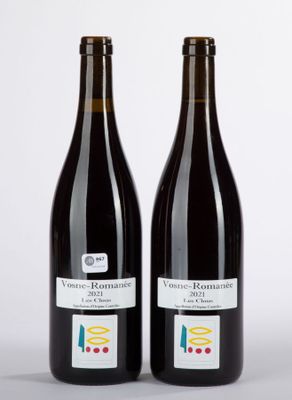 two bottles of wine sitting next to each other on top of a table