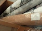 a close up of a bed with a blanket on top of it