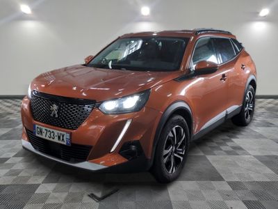 the orange suv is parked in a large room with a checkered floor