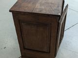 a small wooden cabinet with a drawer on top of it