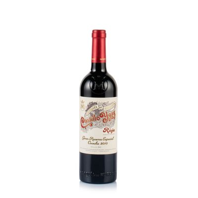 a bottle of red wine sitting on top of a white table