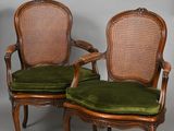 pair of antique cane back chairs with green velvet upholstered cushions