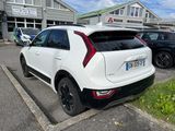 a white car parked in a parking lot next to a building