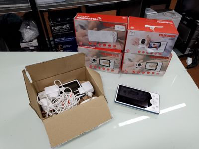 trois boîtes contenant des appareils électroniques posées les unes à côté des autres sur une table