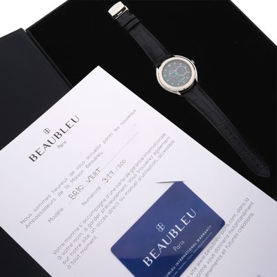 a watch sitting on top of a box next to a credit card