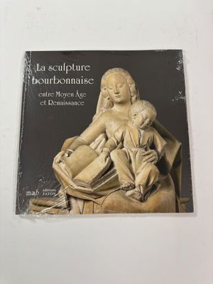 the cover of a book with a statue of a woman holding a child