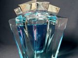 a glass vase with a blue liquid inside of it