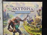 a box of skytopia next to a box of the game
