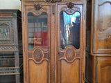 a large wooden cabinet with a mirror on top of it