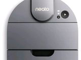 a gray robot that is sitting on a white surface