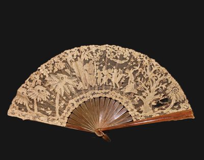 an ornately decorated fan is displayed against a black background