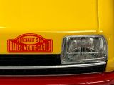 a close up of a yellow truck with a sign on the front