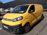 a yellow van that is parked in a parking lot