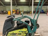 a small machine that is sitting on a pallet in a warehouse
