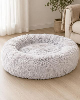 a close up of a dog bed on a wooden floor in a living room