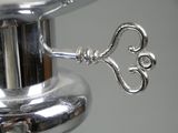 a silver metal object with a key on top of it