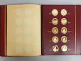 an open book with gold coins in it sitting on a table