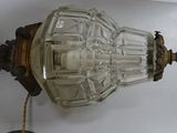 a glass lamp that is hanging on the wall