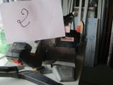 a sign that says s on a piece of paper on a cluttered desk