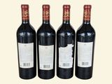 three bottles of red wine sitting next to each other on a table