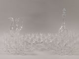 a lot of wine glasses and a decanter on the table
