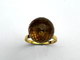 a close up of a ring with a brown stone on it