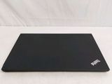 a black laptop sitting on a white surface