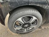 a tire on the side of a car that is dirty
