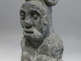 an image of a stone sculpture of a man with a goat ' s head on it ' s head