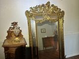 a mirror sitting on the floor next to a dresser