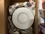 a cardboard box with a white bowl inside of it
