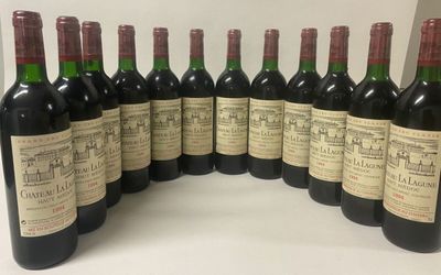 six bottles of wine lined up in a row on a table